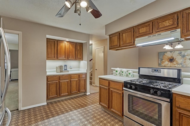 kitchen featuring a textured ceiling, stainless steel appliances, and ceiling fan