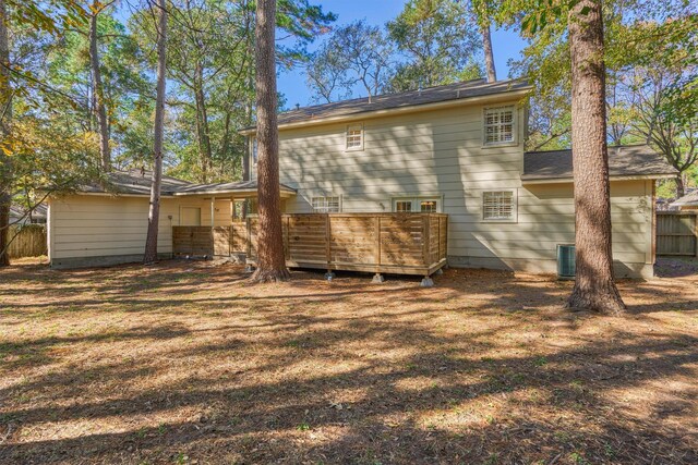 rear view of house with a deck and central AC unit