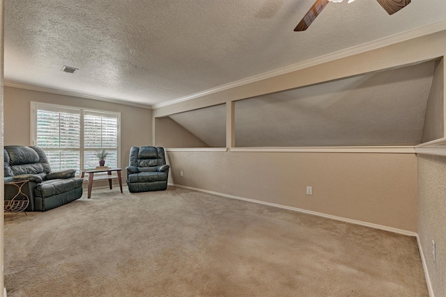 living area featuring carpet flooring, ornamental molding, a textured ceiling, and vaulted ceiling