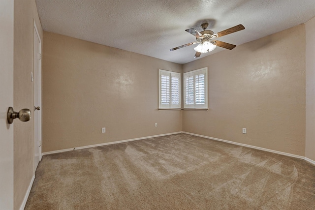 unfurnished room featuring a textured ceiling, light colored carpet, and ceiling fan