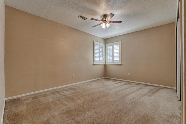 carpeted empty room with a textured ceiling