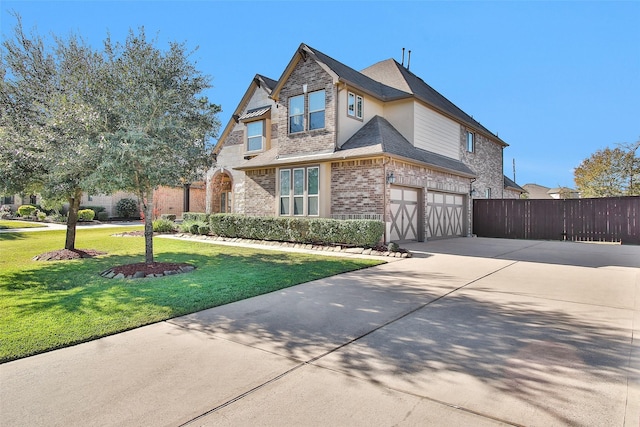 view of front of home featuring a front lawn and a garage