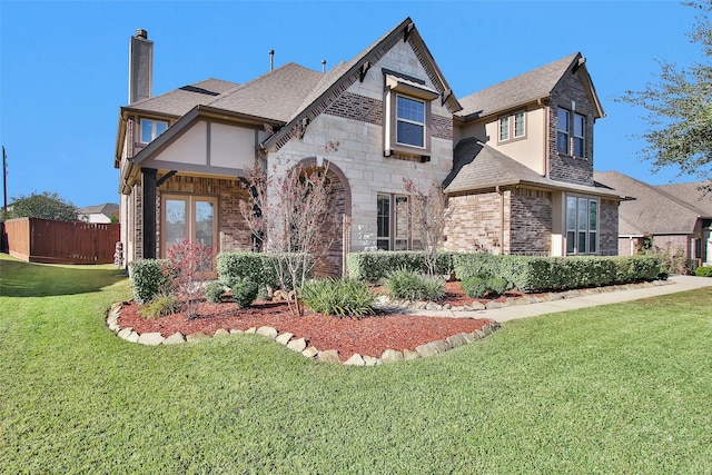 view of front facade with french doors and a front lawn