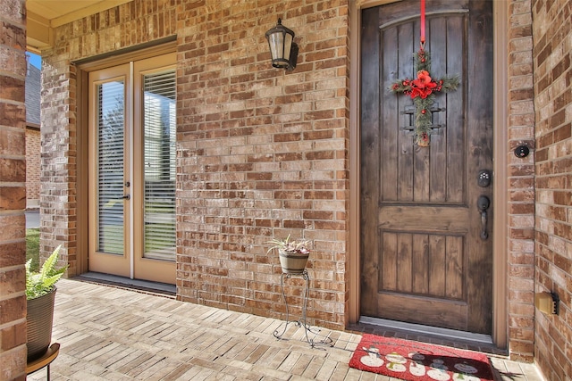 view of exterior entry with covered porch