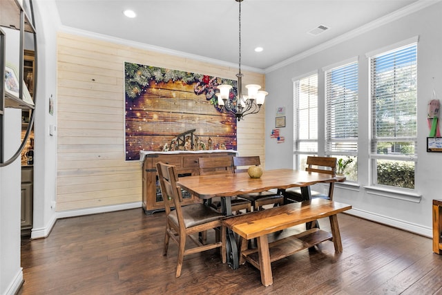 dining space with plenty of natural light, dark hardwood / wood-style flooring, and wooden walls