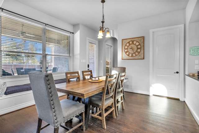 dining space featuring dark hardwood / wood-style flooring and a notable chandelier