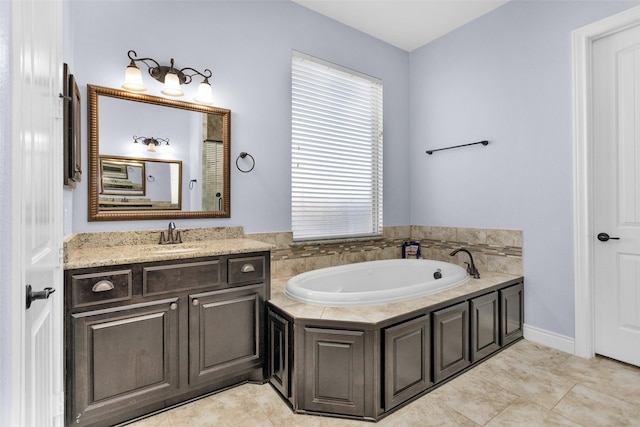 bathroom with tile patterned flooring, vanity, and a bath