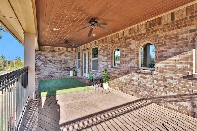 wooden deck featuring ceiling fan