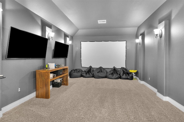 carpeted home theater featuring lofted ceiling