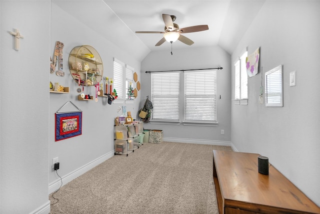 recreation room with carpet flooring, ceiling fan, a healthy amount of sunlight, and vaulted ceiling