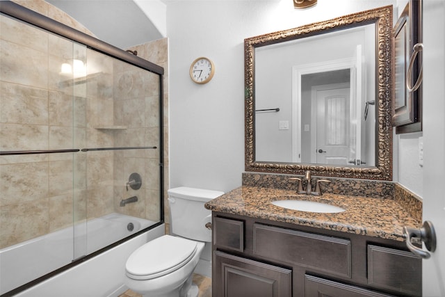 full bathroom featuring combined bath / shower with glass door, vanity, and toilet