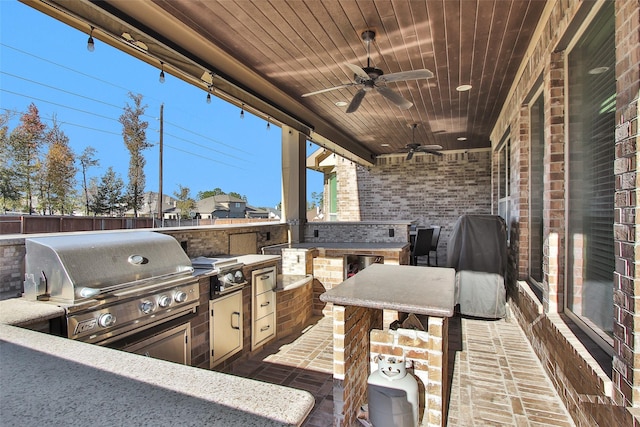 view of patio / terrace featuring ceiling fan, exterior kitchen, and grilling area