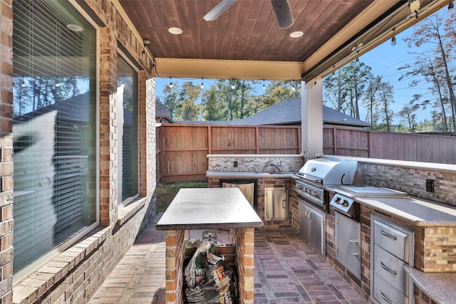 view of patio featuring sink, an outdoor kitchen, ceiling fan, and a grill