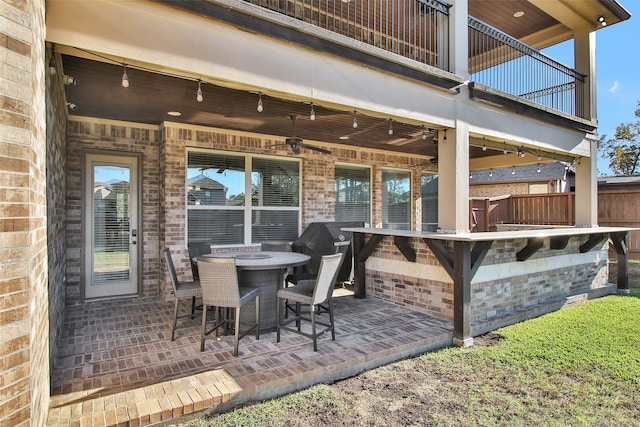 view of patio with grilling area and a balcony