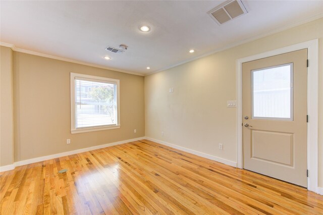 unfurnished room featuring light hardwood / wood-style flooring and crown molding