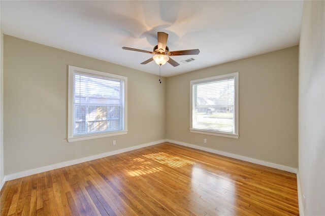 empty room featuring ceiling fan and light hardwood / wood-style floors