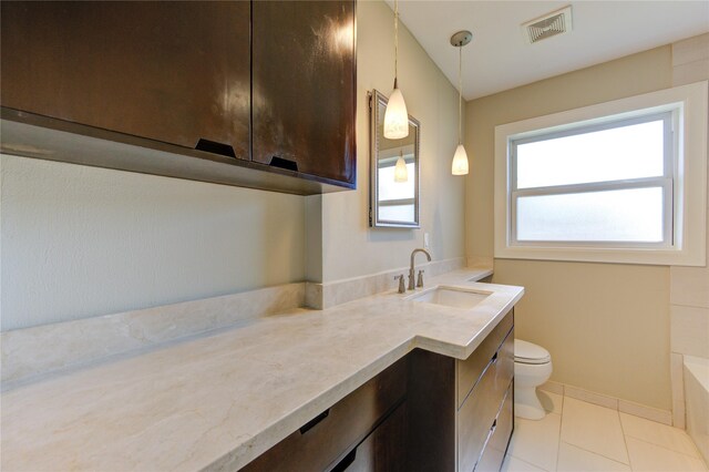 bathroom with tile patterned flooring, vanity, and toilet