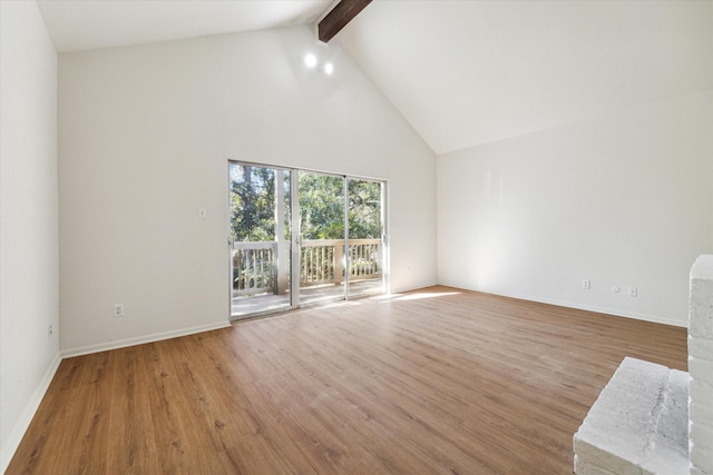 unfurnished living room featuring hardwood / wood-style floors, beamed ceiling, and high vaulted ceiling