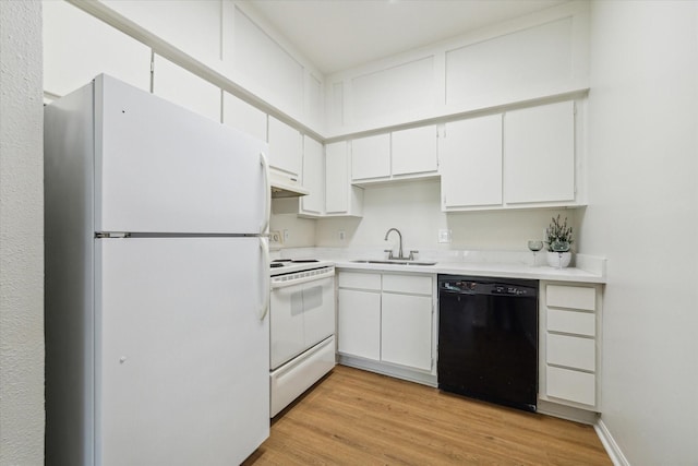 kitchen with white cabinets, white appliances, sink, and light hardwood / wood-style flooring