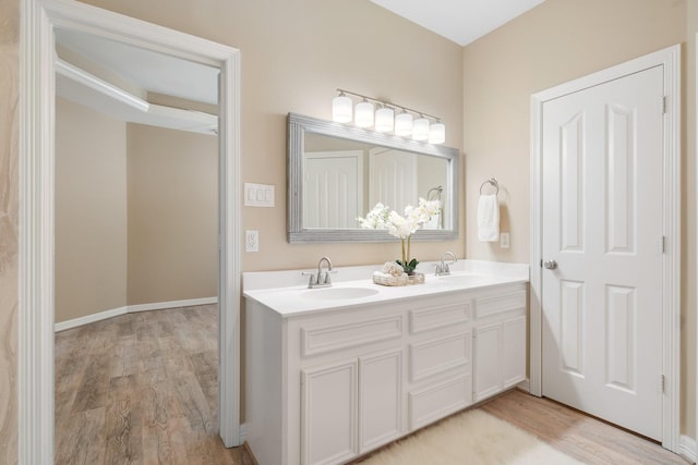 bathroom with hardwood / wood-style flooring and vanity