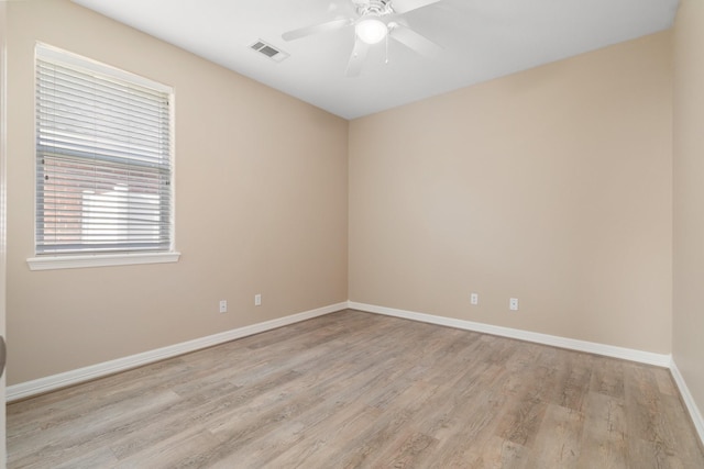 spare room featuring ceiling fan and light hardwood / wood-style flooring