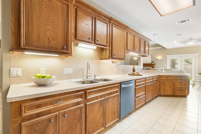 kitchen featuring dishwasher, sink, ceiling fan, light tile patterned floors, and kitchen peninsula