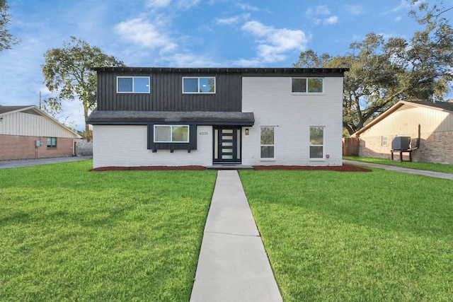 view of front of house with french doors and a front lawn