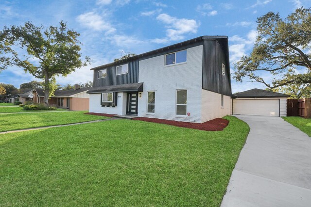 view of front of house with a front yard and a garage