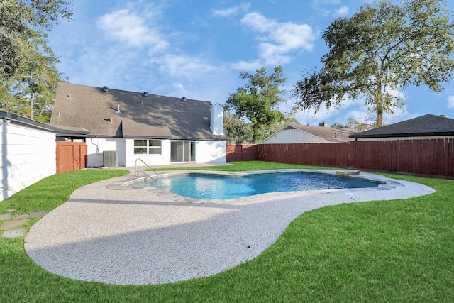 view of pool with a lawn, central AC, and a patio