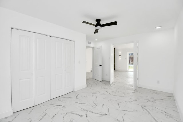 unfurnished bedroom with ceiling fan and a closet