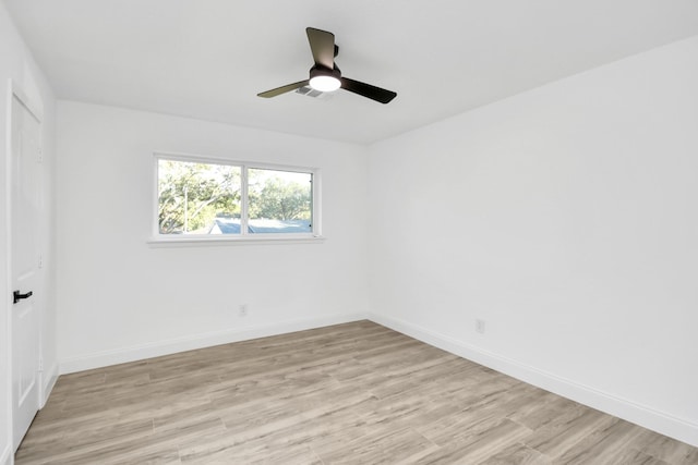 empty room with ceiling fan and light hardwood / wood-style flooring