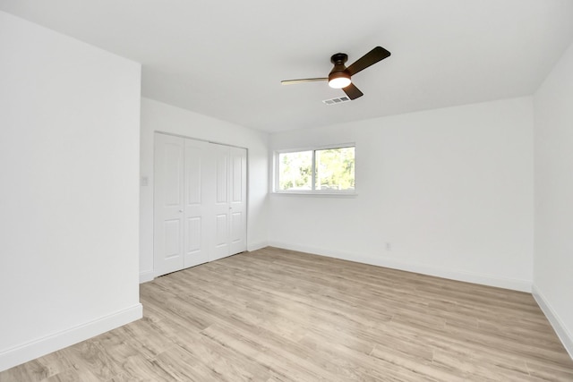 empty room with ceiling fan and light wood-type flooring