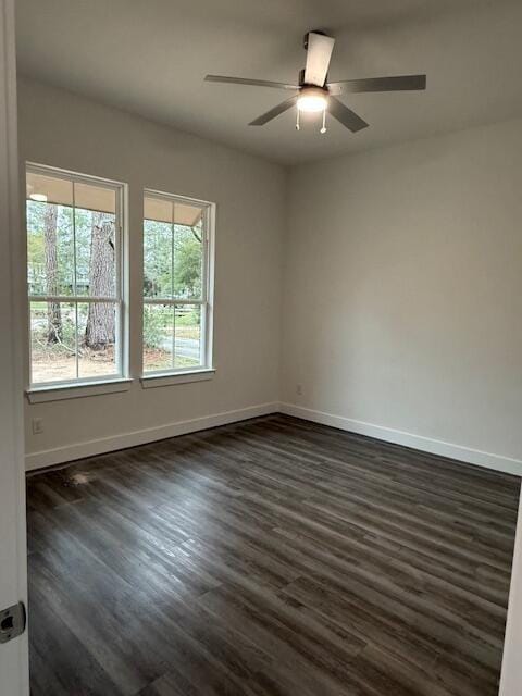 unfurnished room with dark hardwood / wood-style floors and ceiling fan