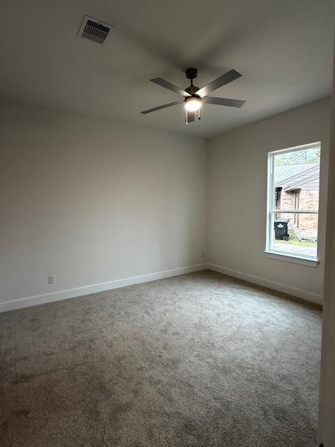 empty room with carpet floors and ceiling fan