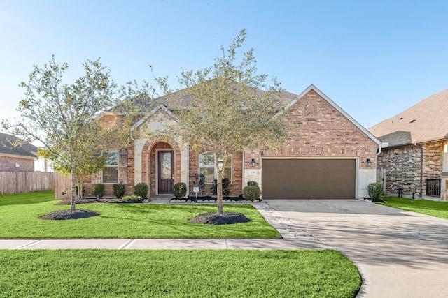 view of front of property featuring a front yard and a garage