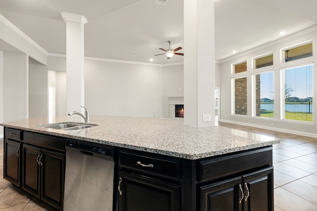 kitchen with dishwasher, ceiling fan, light stone counters, and sink