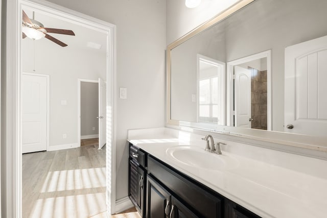 bathroom featuring ceiling fan, vanity, and wood-type flooring