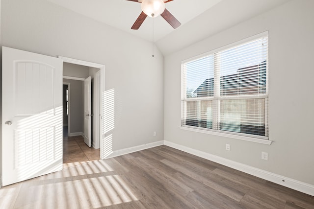 unfurnished bedroom featuring ceiling fan, lofted ceiling, and hardwood / wood-style flooring