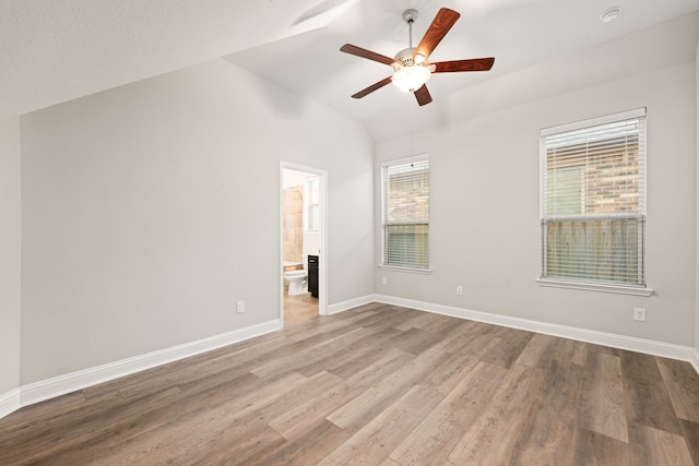 spare room with ceiling fan, lofted ceiling, and light wood-type flooring