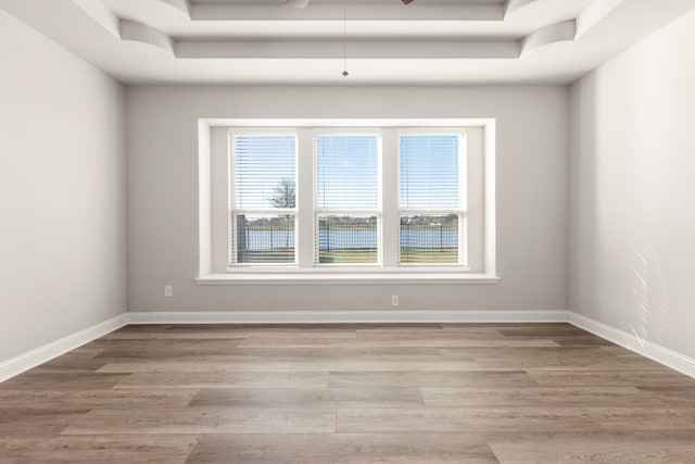 unfurnished room featuring a water view, a wealth of natural light, and light hardwood / wood-style flooring