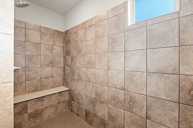 bathroom with a tile shower