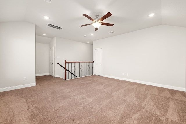 carpeted empty room with ceiling fan and lofted ceiling