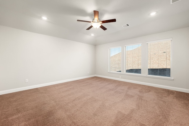 carpeted spare room featuring ceiling fan