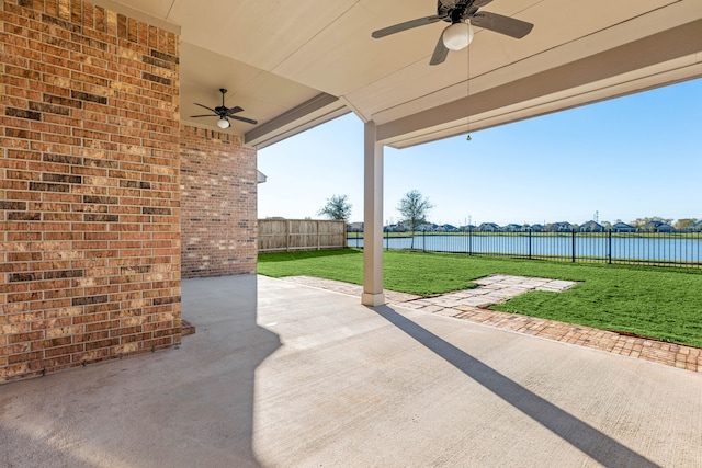 view of patio / terrace with ceiling fan and a water view