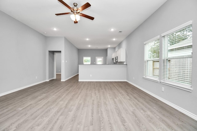 unfurnished living room featuring light hardwood / wood-style floors and ceiling fan