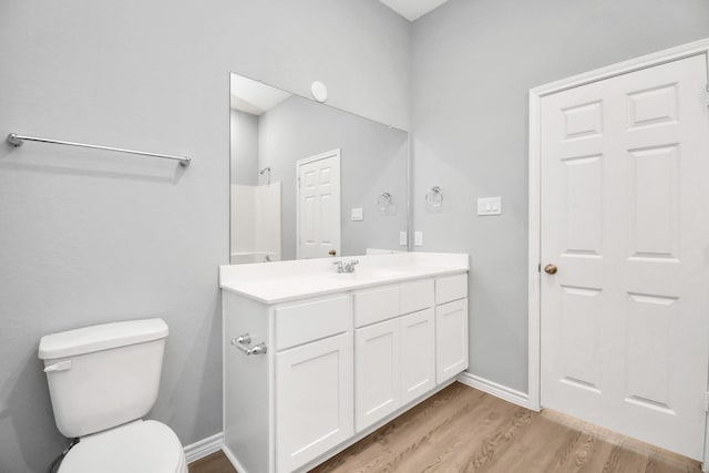 bathroom featuring hardwood / wood-style flooring, vanity, and toilet