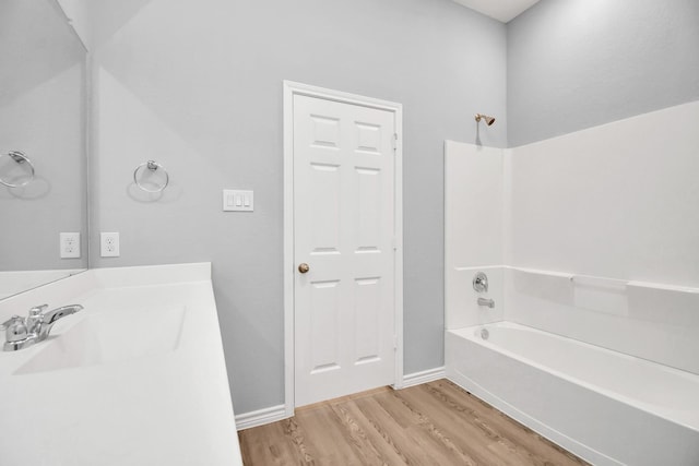 bathroom featuring wood-type flooring and sink