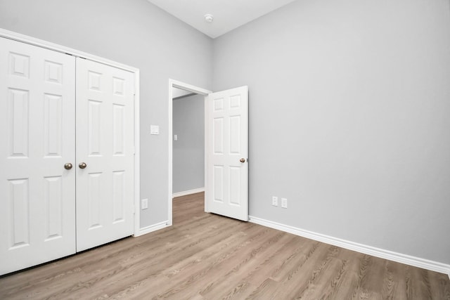 unfurnished bedroom with a closet and light hardwood / wood-style flooring