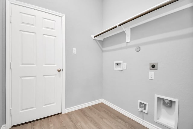 clothes washing area featuring hookup for an electric dryer, washer hookup, light wood-type flooring, and gas dryer hookup