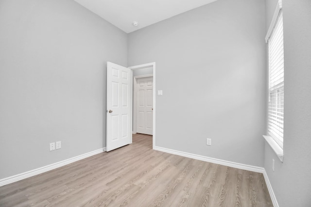 spare room with light hardwood / wood-style floors and plenty of natural light